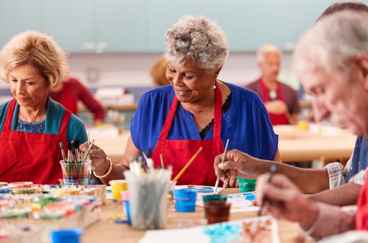 Seniors enjoying a community art class at a local center — creativity and connection foster wellness.